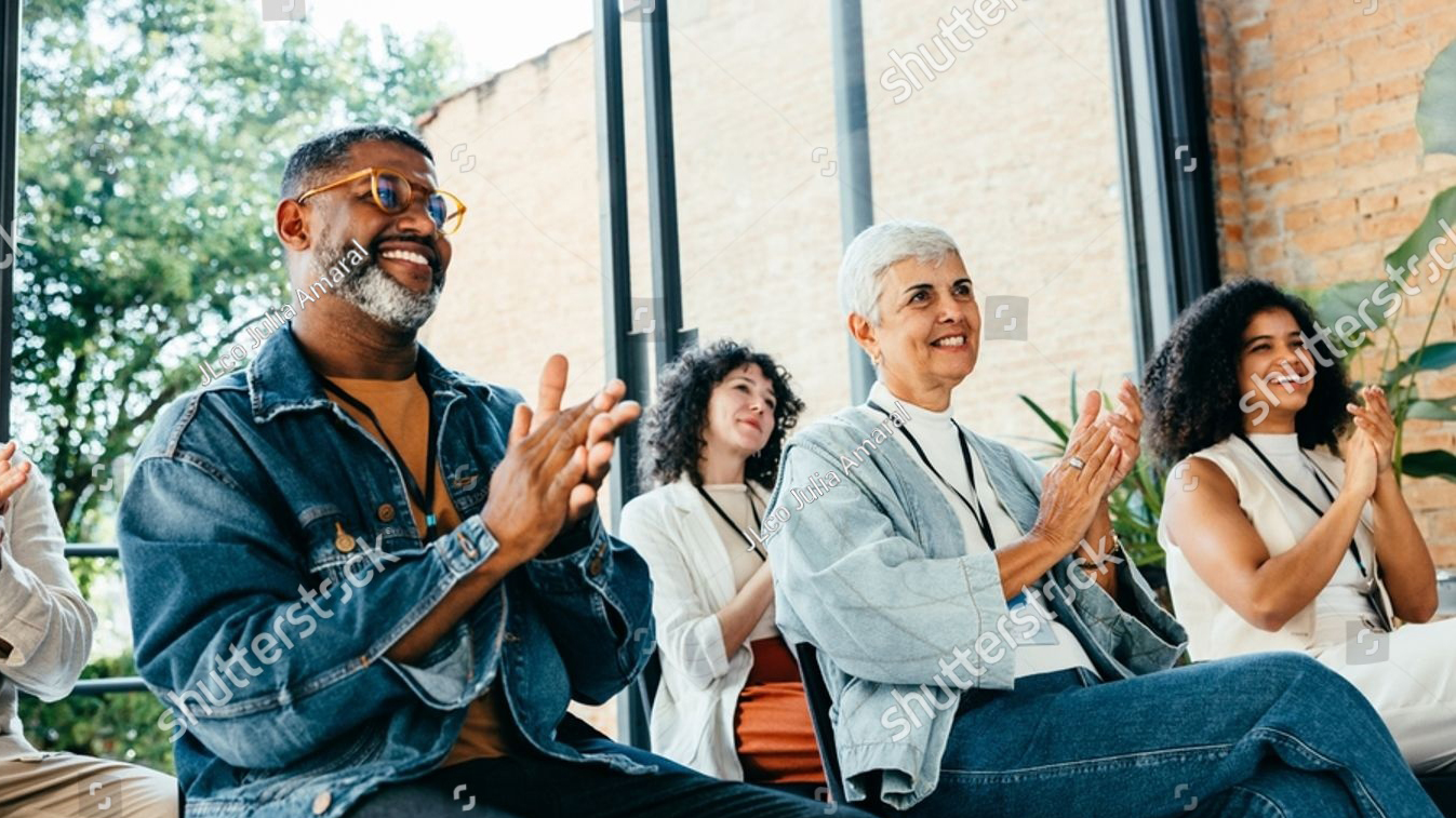 People clapping in meeting